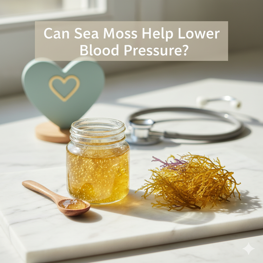 Clear glass jar of golden sea moss gel and a wooden spoon on a marble surface, with raw sea moss and a subtly blurred stethoscope in the background. Text: "Can Sea Moss Help Lower Blood Pressure?
